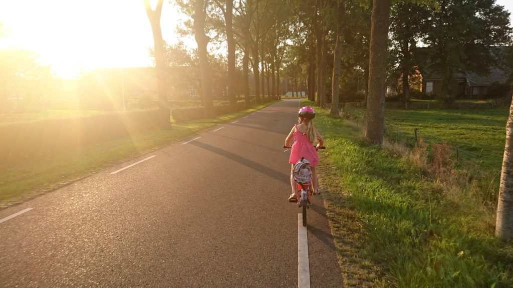 child riding a bicycle on the road